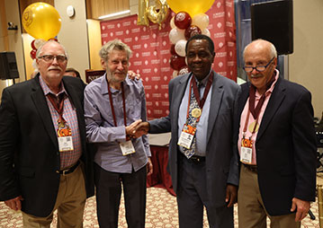 Four men smiling. Links to What to Give Four men smiling. Links to What to Give
